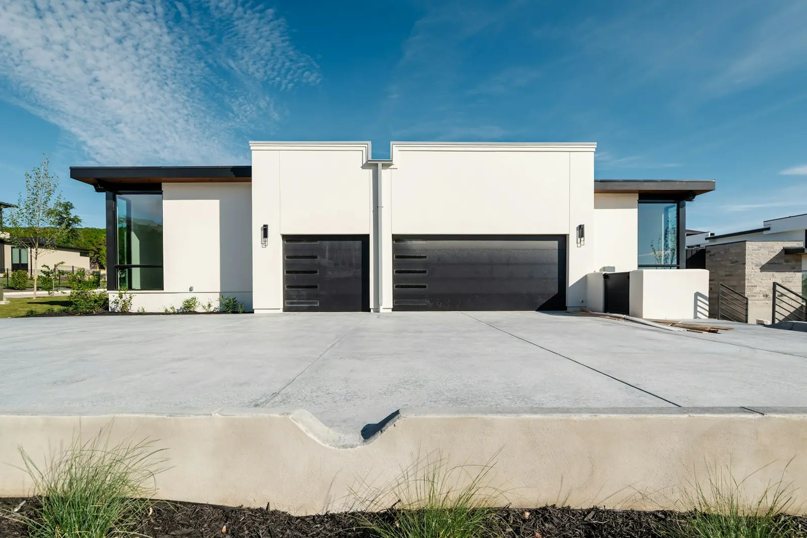 Freshly poured broom-finish concrete driveway in front of a two-story home in Troy, MI